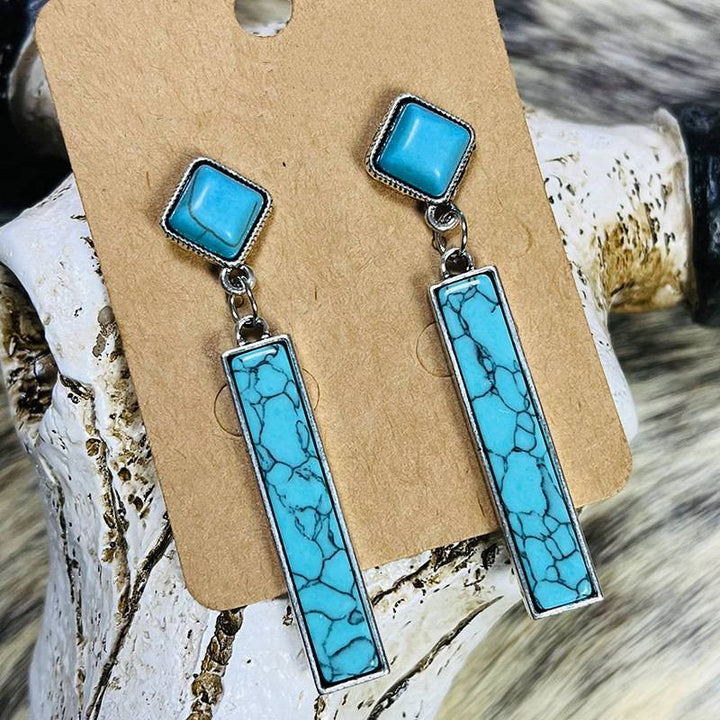 Turquoise drop earrings with silver accents and square top.