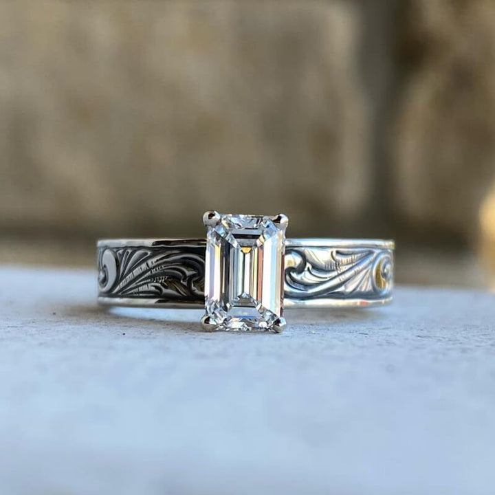 Silver-black engraved band engagement ring with emerald zircon center stone