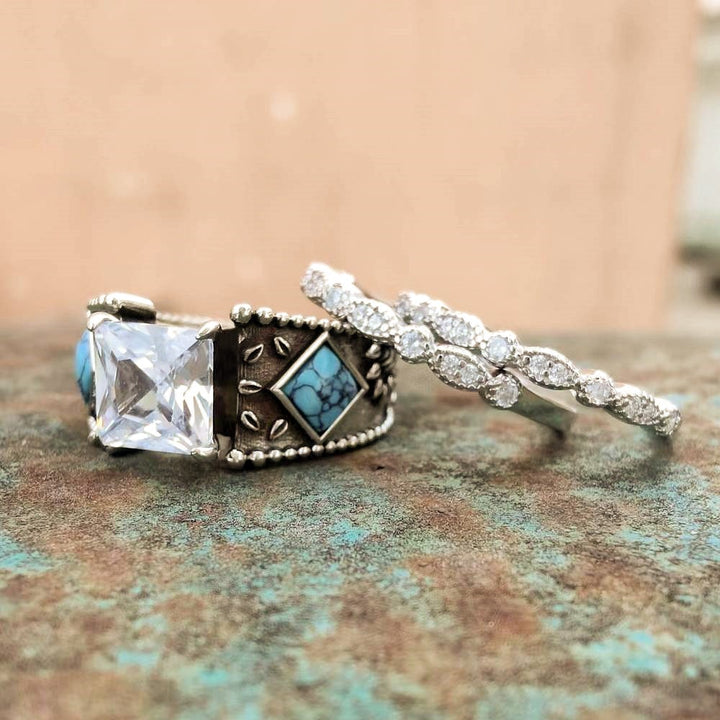 Turquoise and zircons in a vintage silver ring set with intricate designs