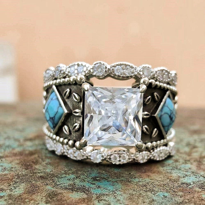 Vintage turquoise and diamond ring set in intricate sterling silver design.