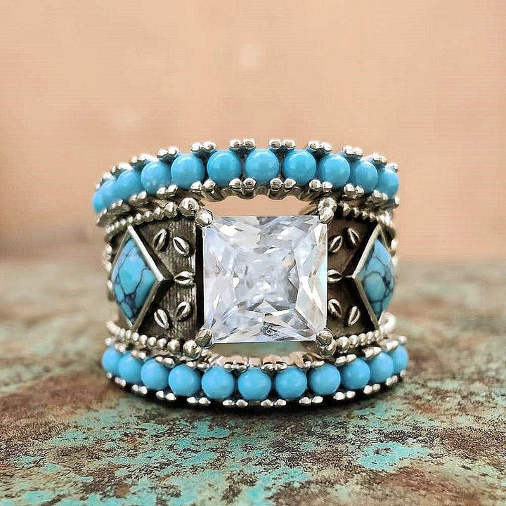 Sterling silver turquoise ring set with square zircon and intricate bead detailing