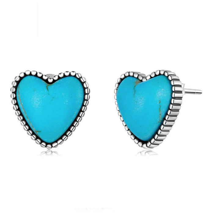 Turquoise heart-shaped stud earrings on a white background