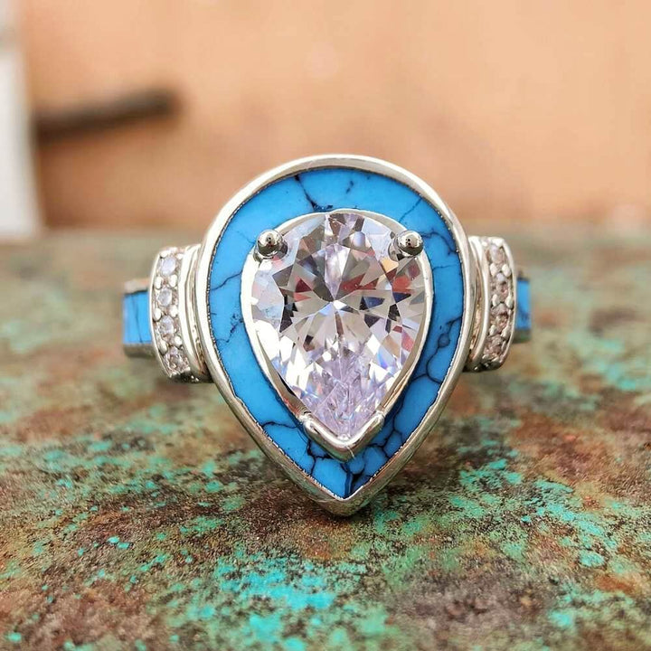 Pear turquoise inlay engagement ring with sparkling diamond and silver accents.