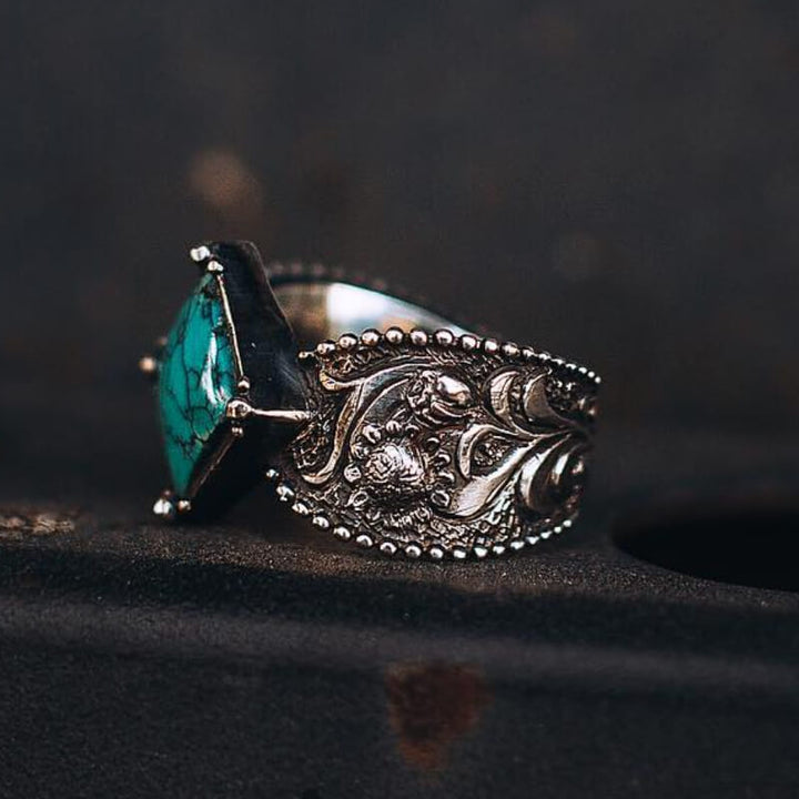 Detailed square turquoise ring with floral designs in a silver setting