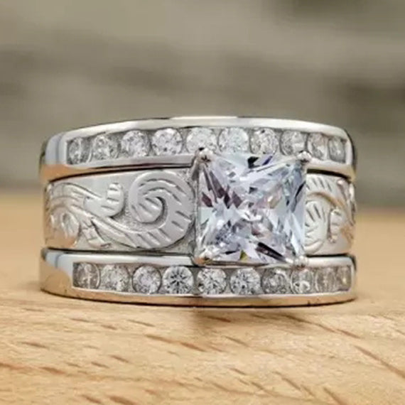 Western wide band ring with zircon centerpiece and engraved design on wood