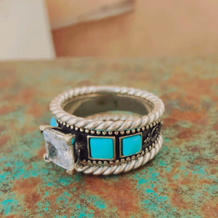 Twist band ring with turquoise squares and a large diamond centerpiece.