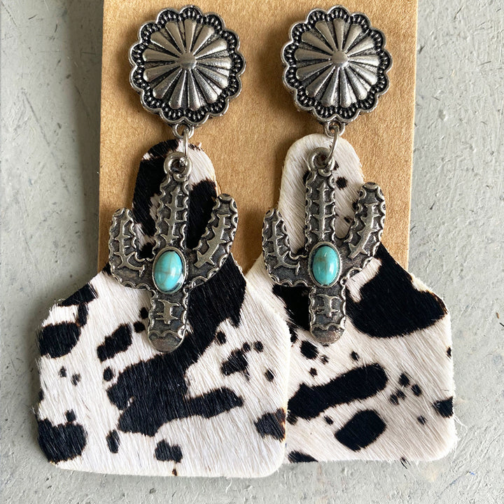 Cactus design earrings with turquoise stone and cow print background