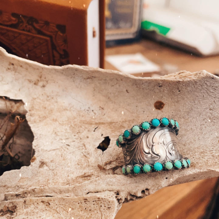 Wide western ring with turquoise stones and ornate floral design for women