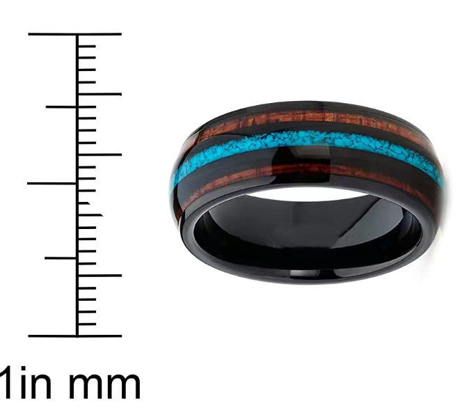 Turquoise and acacia wood three-slot band ring with black finish next to a ruler