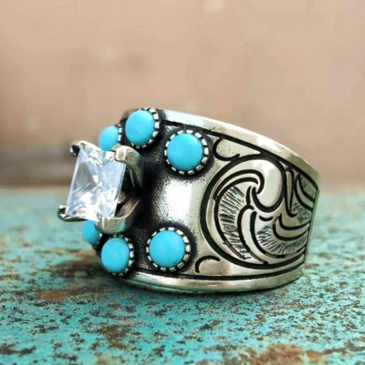 Silver wide band engagement ring with diamond center and turquoise accents