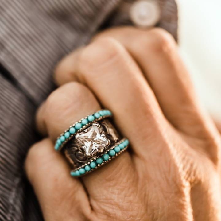 Turquoise and silver band ring with flower engravings and large center gemstone
