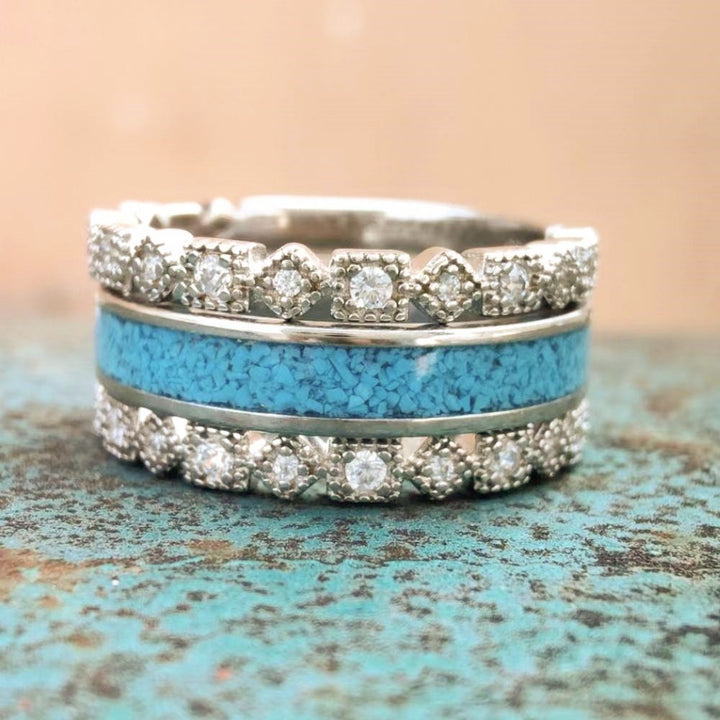 Vintage turquoise and diamond band ring on textured rustic background