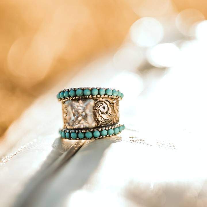 Turquoise flower engraved band ring with intricate designs and clear center stone