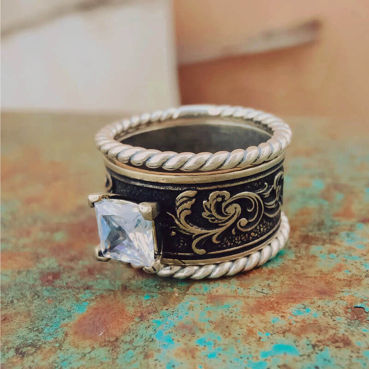 Floral engraved sterling silver ring with large square clear zircon stone.