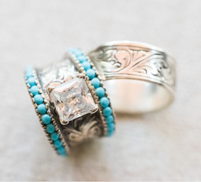 Silver band ring with turquoise stones and a clear center gemstone