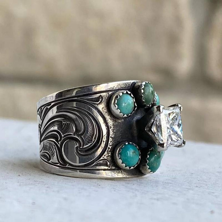 Turquoise engagement ring with diamond center and silver floral engravings