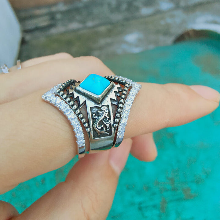 Sterling silver ring with square turquoise stone and intricate engravings