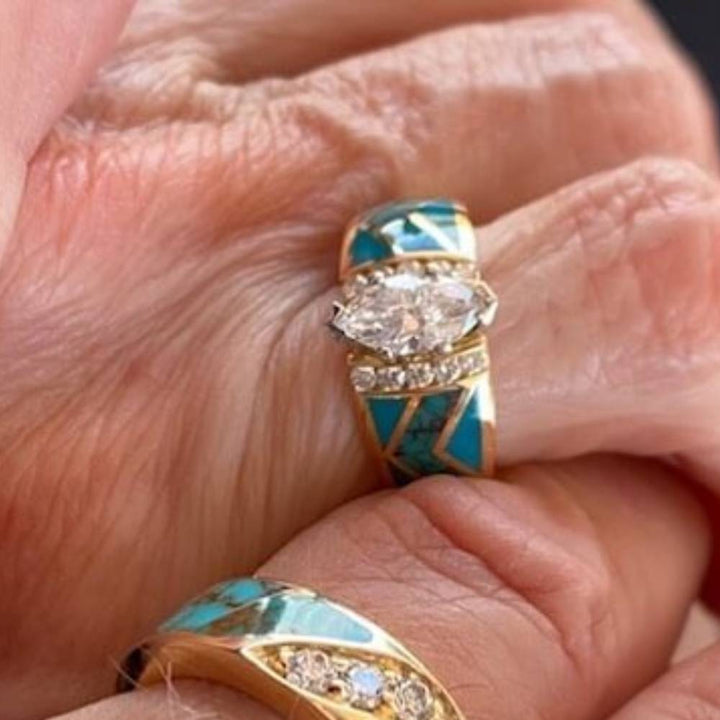 Gold engagement ring featuring marquise diamond center and turquoise inlays with accents