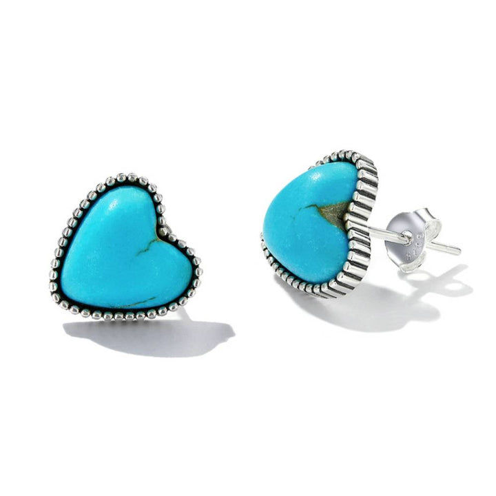 Silver heart turquoise stud earrings on a white background