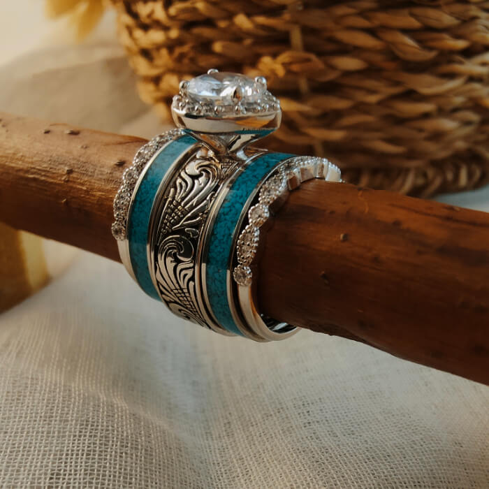 Three stacked wedding rings with pear diamond and turquoise accents
