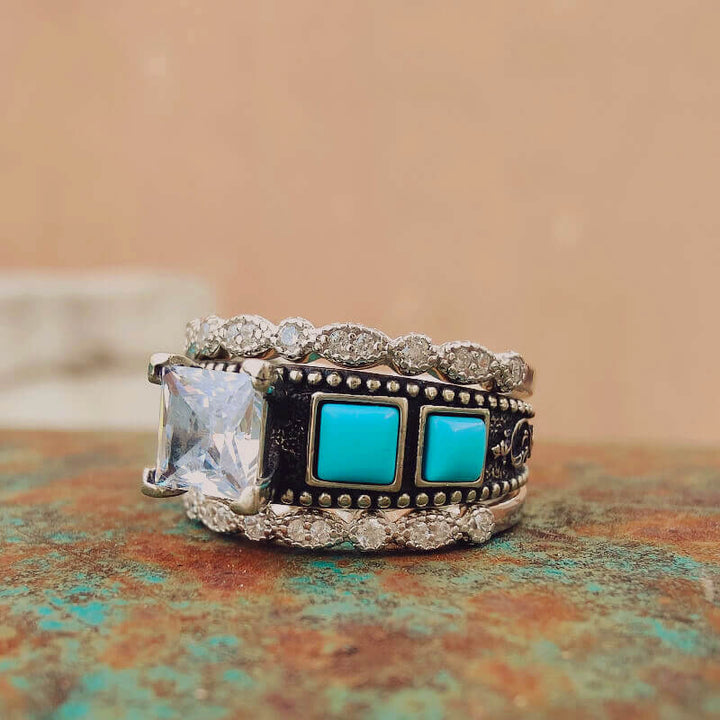 Square zircon turquoise ring set with vintage floral band and diamond accents.
