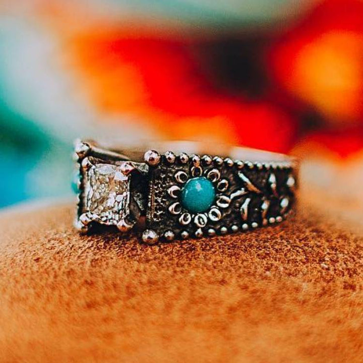 Vintage turquoise and diamond engagement ring with floral design.