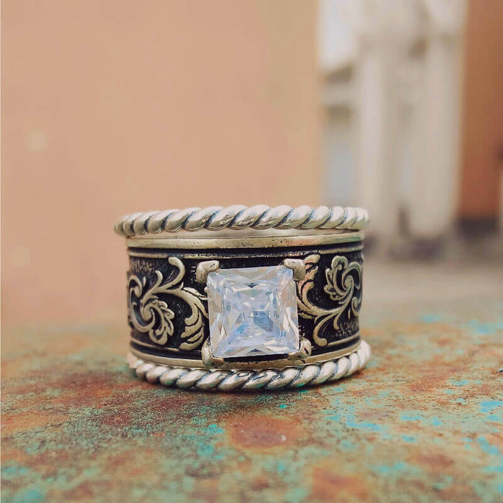 Sterling silver floral band ring with square zircon stone and twisted rope design.
